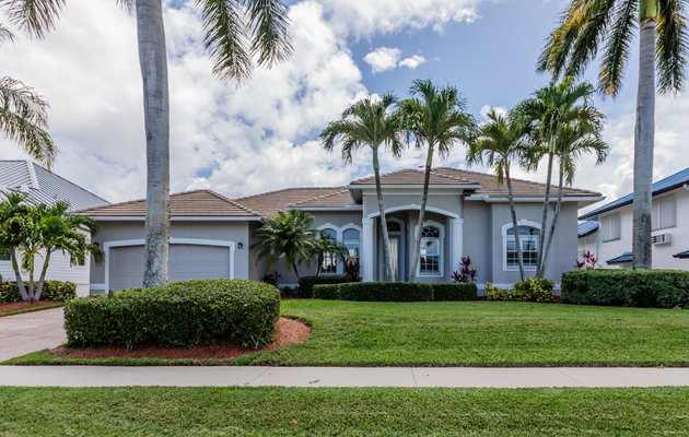 Elegant stone driveway with green hedges